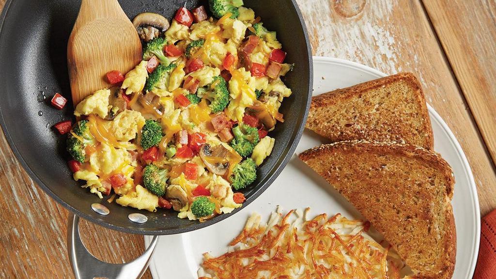 Y.O. Scramble · The PERFECT scramble built YOUR way! Choose your cheese, protein and veggies for a creative taste as unique as you are! Served with choice of two breakfast sides.