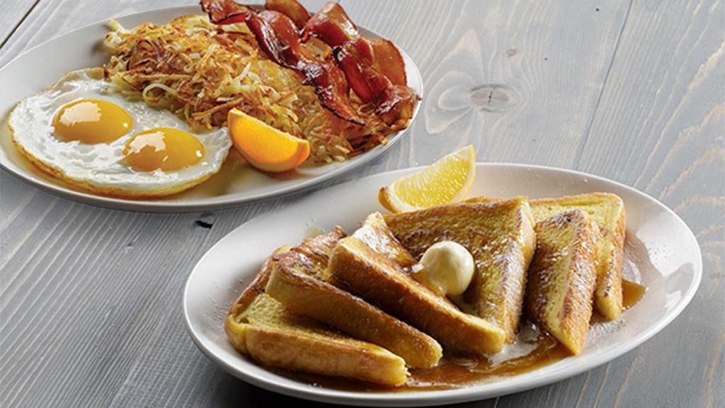 Brioche French Toast Combo · Rich brioche bread makes our French toast light, fluffy and decadent; dipped in our French toast mix and grilled to perfection. Served with two eggs* and choice of breakfast meat. Includes syrup.