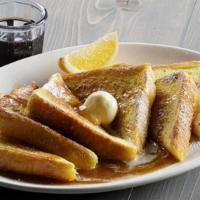 Brioche French Toast · Rich brioche bread makes our French toast light, fluffy and decadent; dipped in our French t...