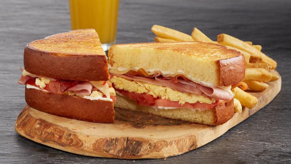 The Shari'S Classic · Creamy scrambled eggs*, bacon, grilled ham, grilled tomato, choice of cheese and mayo on grilled brioche bread. Includes choice of side.