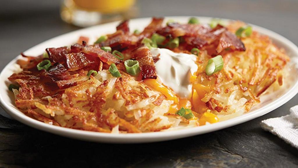 Side Of Stuffed Hash Browns · Our crispy hash browns are stuffed with sour cream and cheddar cheese then topped with crispy Applewood-smoked bacon and green onions.