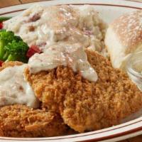 Ultimate Country Fried Steak · A tender, homestyle country fried steak smothered in savory sausage gravy and served with tw...