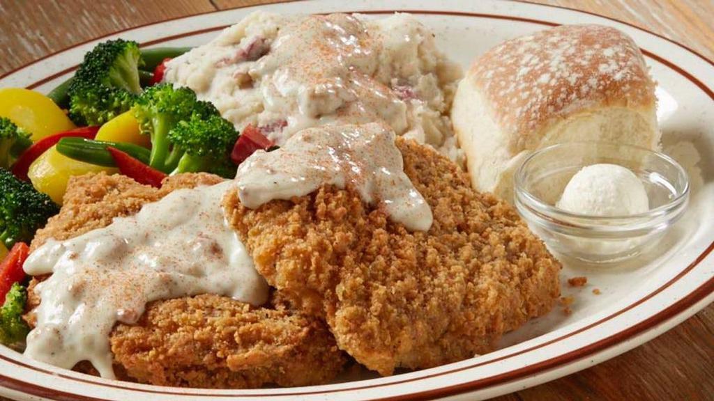 Ultimate Country Fried Steak · A tender, homestyle country fried steak smothered in savory sausage gravy and served with two dinner sides.
