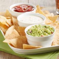 The Trio Dip & Chips · Queso, guacamole, salsa and chips.