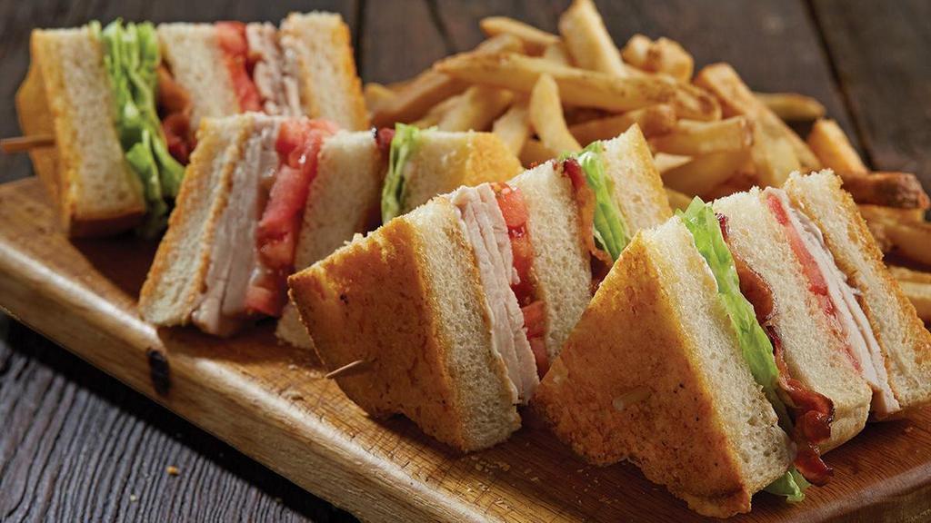 Turkey Bacon Club · Hand-carved turkey breast, Applewood-smoked bacon, crisp lettuce, fresh tomatoes and mayo on thick-cut Parmesan-crusted sourdough. Served with choice of side.