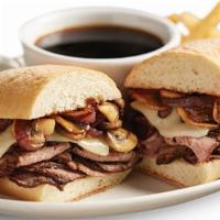 Philly-Style Prime Rib Dip · A prime rib dip with a Philadelphia accent! Hot off the griddle sliced prime rib topped with...
