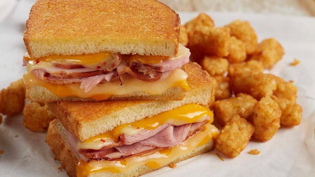 Grilled Ham & Four-Cheese Melt · Tillamook® cheddar, pepper jack and Swiss layered with tender, hand-carved ham on thick-cut Parmesan-crusted sourdough. Served with choice of side.