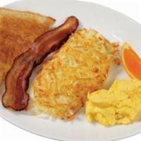 Homesteader Breakfast · A scrambled egg served with bacon, toast and choice of one side.