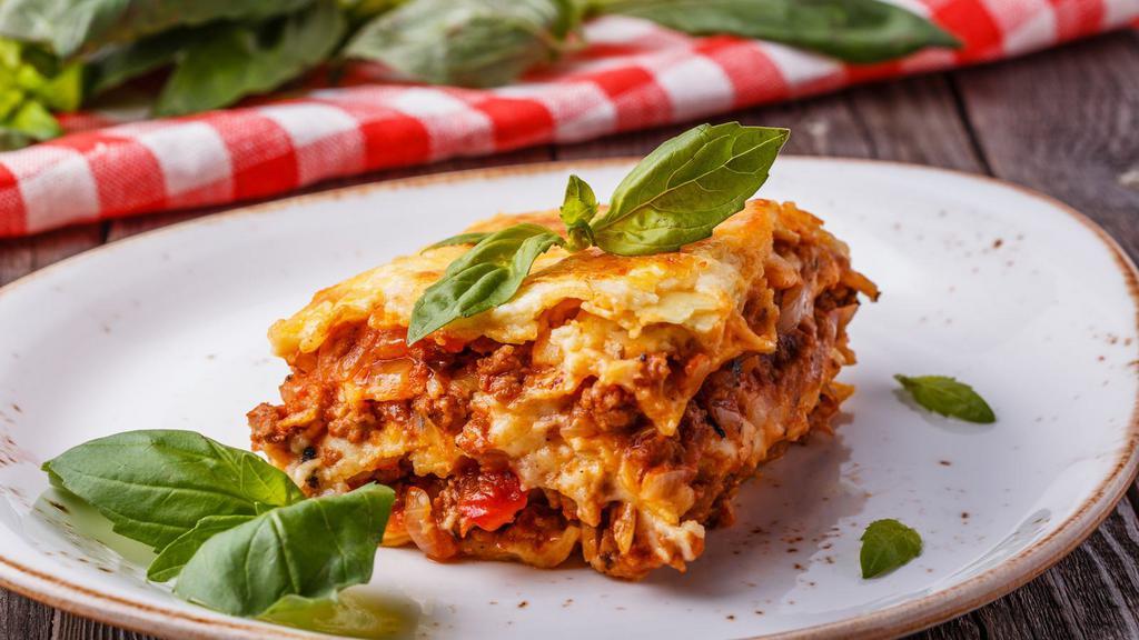 Meat Lasagna · Mouthwatering pasta dish made with layers of Meat, lasagna noodles, mozzarella cheese, parmesan cheese, and tomato sauce.