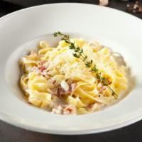 The Fettuccine Carbonara · Fresh fettuccine pasta with canadian bacon, onions, diced tomatoes, garlic pieces all mixed ...
