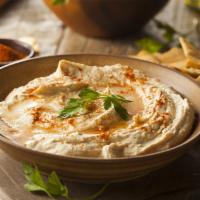 Hummus · A delightful dip of mashed Garbanzo beans, Tahini, garlic, lemon juice, and olive oil.