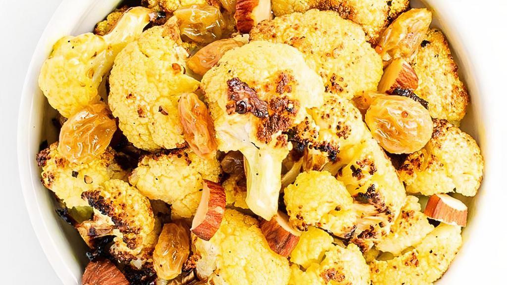 Curried Cauliflower · with Golden Raisins & Almonds