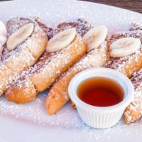 Cinnamon French Toast · Three thick toast dipped in vanilla and cinnamon egg batter, with banana, whipped cream, and...
