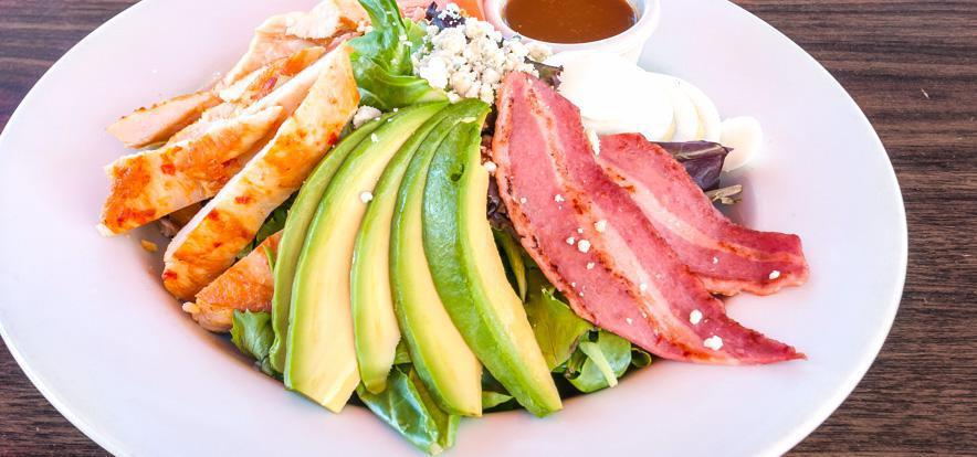 Cobb Salad · Turkey bacon, chicken, boiled egg, tomato, mixed greens, blue cheese, and house dressing.