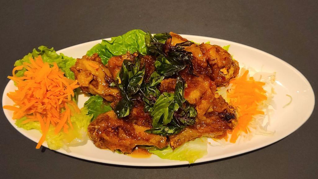 Angel Wings · Deep - fried chicken wings glazed with sweet and spicy tamarind sauce and crispy basil on top.