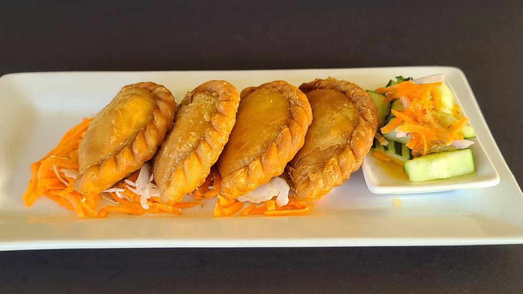 Chicken Curry Puff · Deep - fried curry puff stuffed with chicken, potatoes, onion and carrot served with cucumber salad