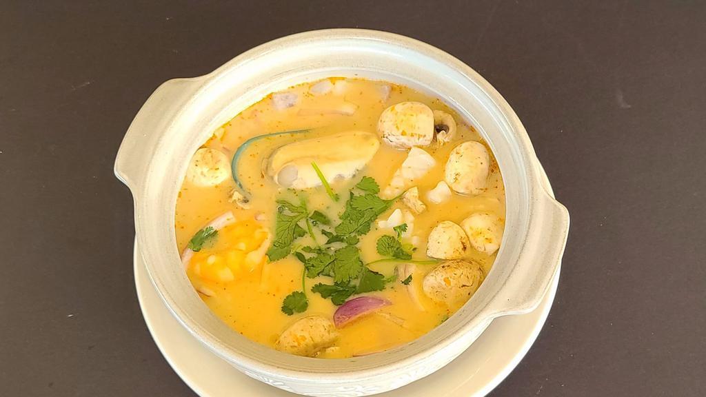 Tom Kha Talay · Combination seafood of prawn, calamari, scallop and mussel in coconut milk with red onion, mushroom, cilantro and roasted chilli.
