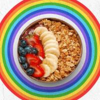 Spirit Guide Acai Bowl · Acai bowl topped with granola, bananas, blueberries, strawberries, and honey.