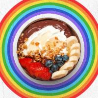 Earth Medicine Acai Bowl · Acai bowl topped with  greek yogurt, granola, bananas, strawberries, blueberries, and honey.