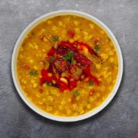 Dial Up The Dal Tadka  · Split pea lentil cooked with garlic, tomato, mustards, and curry leaves.