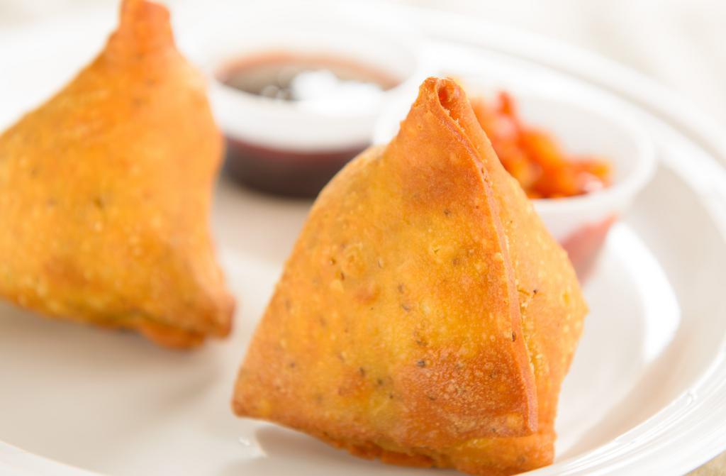 Samosa (2) · Vegan. Deep fried patties stuffed with fresh potatoes, green peas and freshly ground Indian spices, served on a bed of salad.
