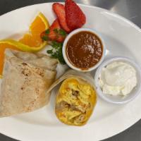 Breakfast Burrito · Eggs with sausage, tomatoes, cheddar cheese, sour cream, fresh salsa rolled in a flour torti...