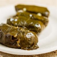 Dolmas (4pcs) · Stuffed grape leaves with rice, vegetables, lemon and olive oil fool salad fava and garbonzo...