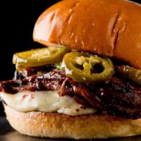 Jalapeño Cheeseburger · Chopped jalapenos topped on 6 oz. black Angus beef served on toasted bun and pickles.