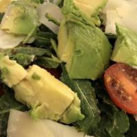 Dinner Benessere Insalate · Organic baby kale, avocado, cherry tomatoes, quinoa, and shaved pecorino cheese in an avocad...