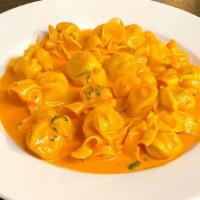 Fioccheti Aurora · Pasta pockets stuffed with pear and Asiago cheese in creamy tomato sauce