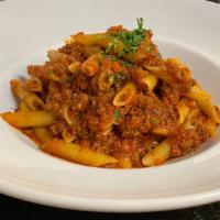 Penne alla Bolognese · Penne past with our traditional homemade meat sauce