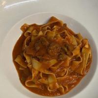Pappardelle Al Sugo D'agnello · Homemade flat ribbons of pasta with tomato lamb stew.