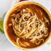 Birria pho · Birria and pho noodles with consome, cilantro and onion.
