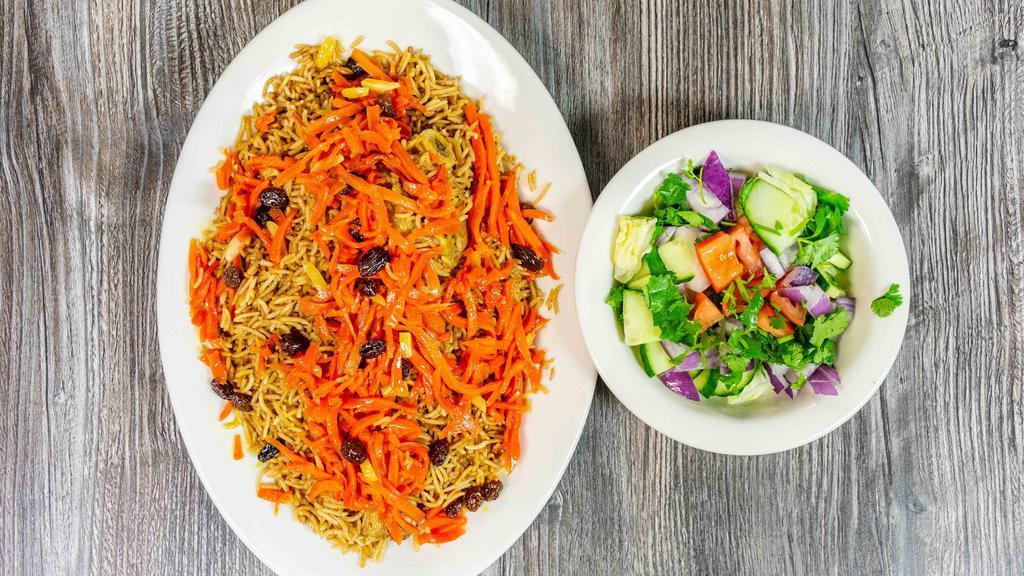 Quabili Pallow · Afganistan's most popular dish, most popular dish, brown basmati rice with lamb shank, topped with sauteed raisins and julienned carrots.