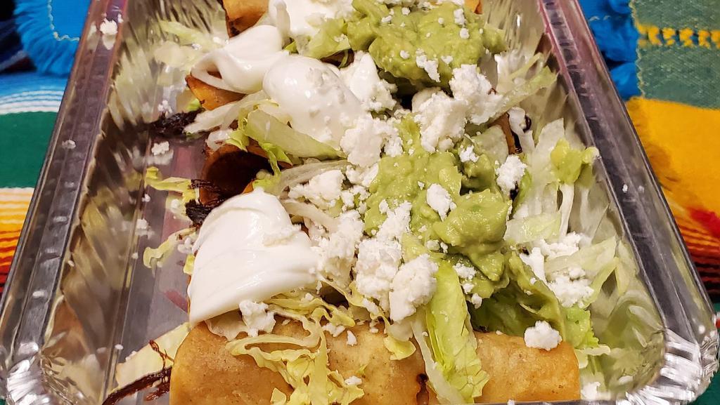 Mini Flautas · Chicken or Picadillo, Wrapped in Corn Tortilla, Served with Fresh Cheese, Sour Cream, Guacamole, and Lettuce.