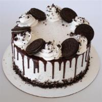 Chocolate Cookie Crumble Froyo Cake  · Oreo explosion! This cake is covered in Oreos and includes White Cake, Cookies & Cream and V...