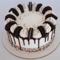 Sprinkles ‘N Cream Froyo Cake · This cake was made to party! Topped with Oreo Cookies, Nonpareils, and Chocolate Fudge. Fill...