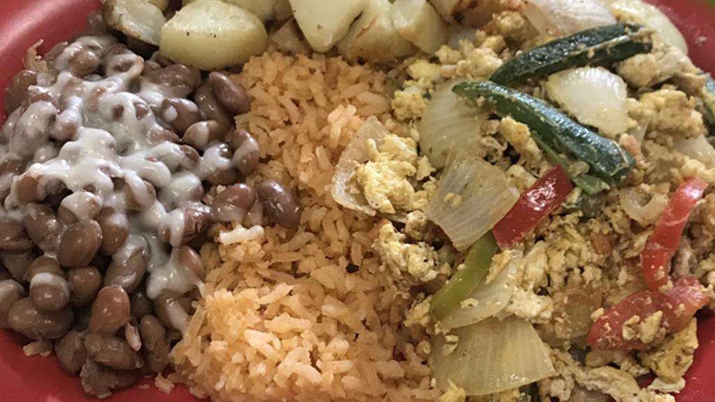 Huevos A La Mexicana (Veggie) · Scrambled eggs mix with tomatoes, onions, jalapeños and bell pepper. Served with rice, beans, cheese potatoes and tortillas.