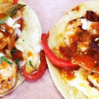 Shrimp Taco · Grilled shrimp, onions and bell pepper with melted cheese, onions, cilantro and salsa.