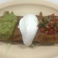 Chimichanga · Fried burrito. Meat, rice, beans and cheese inside topped with sour cream, guacamole and pic...