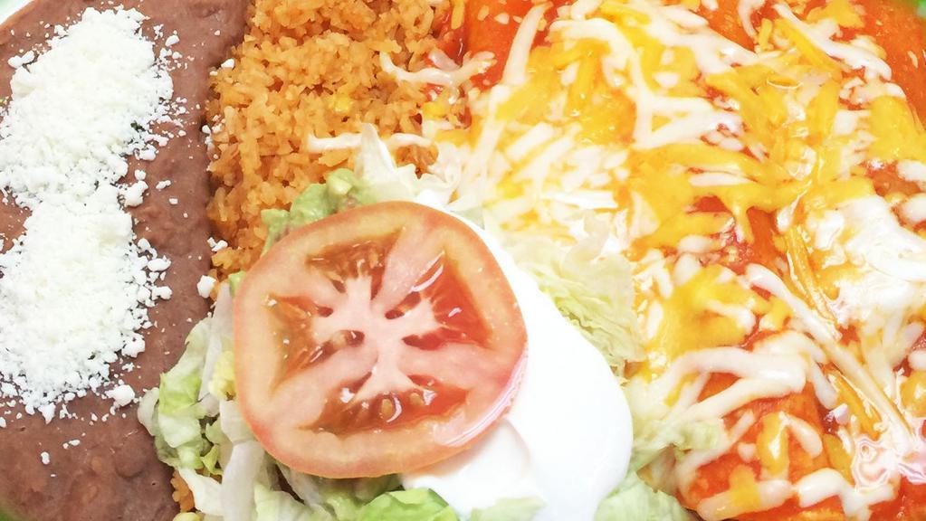 Three Enchiladas · Choice of meat, red or green sauce, topped with cheese, lettuce, guacamole and sour cream, served with rice and beans.