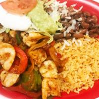 Fajitas de Camaron · Grilled shrimp, onions, tomatoes, and bell pepper. Served with rice, beans, sour cream, guac...