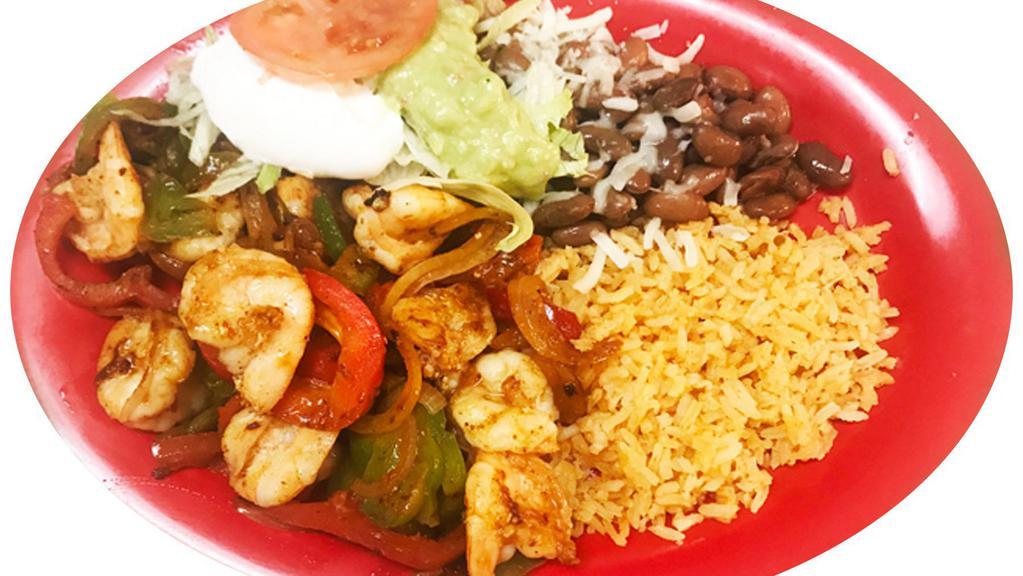 Fajitas de Camaron · Grilled shrimp, onions, tomatoes, and bell pepper. Served with rice, beans, sour cream, guacamole and tortillas.