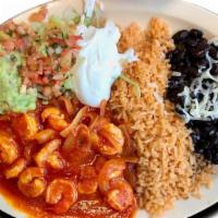 Camarones A la Diabla · Shrimp cooked in red sauce with onions. Served with rice, beans, sour cream, guacamole and t...