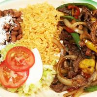 Steak Fajitas · Grilled onions, tomatoes and bell pepper. Served with rice, beans, tortillas, sour cream and...