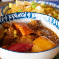 Beef Kaldereta Plate · Tender chunks of meat in a tomato based stew with potatoes, bell peppers, peas and carrots s...