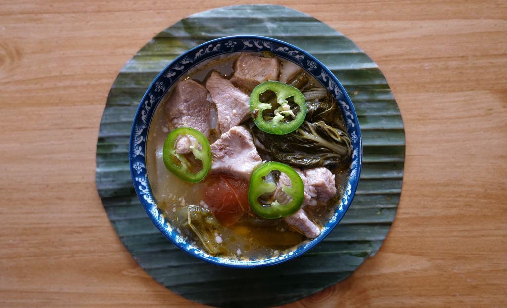Pork Sinigang A la Carte · A Filipino staple, this tamarind based sour soup is delicious on cold days. Contains pork, daikon, tomatoes, onions, bok choy and green beans simmered long and slow . Small feeds 1 to 2 people, Large feeds 3 to 4.