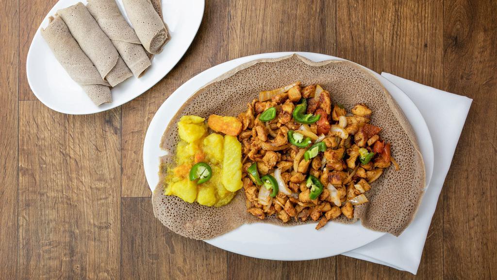 Chicken Tibs · Tender pieces of chicken thigh sauteed in Addis spices, onions, garlic, rosemary and fresh herbs.