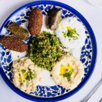 Mezzet Platter · Hummus, Falafel, Baba Ganoush, Tabouleh, and yoghurt served in a platter.