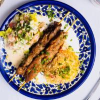 Legionnaire's Lamb Bowl · Skewered pieces of lamb marinated in a blend of herbs and spices served with yellow rice and...